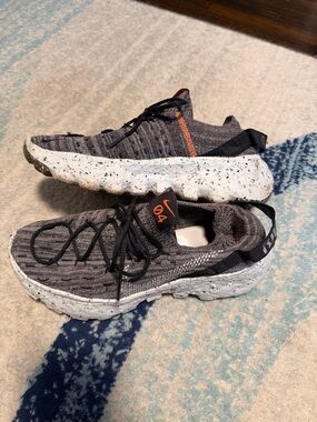 Nike Grey Flyknit Sneakers with Orange Tongue Tab